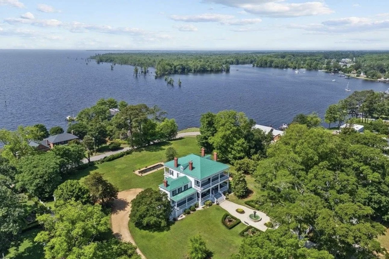 Aerial view of Pembroke Hall, a Greek Revival estate with a green metal roof at 121 W King St, sited on a bluff above Edenton Bay, Edenton, NC